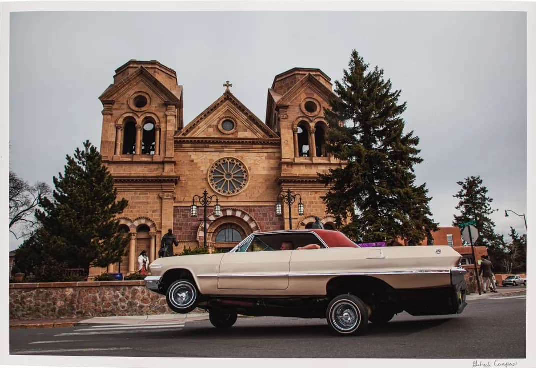 Lowrider car in front of a church.